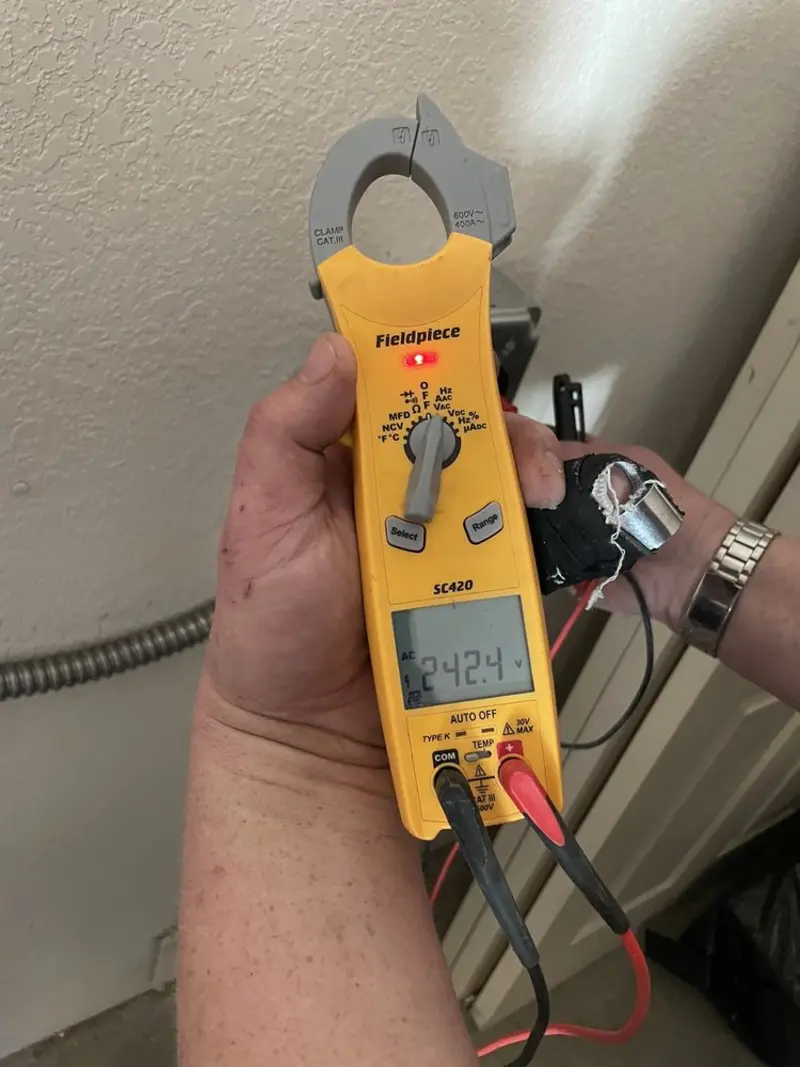 Voltage testing with clamp meter during Electrical Installation Services in Manti